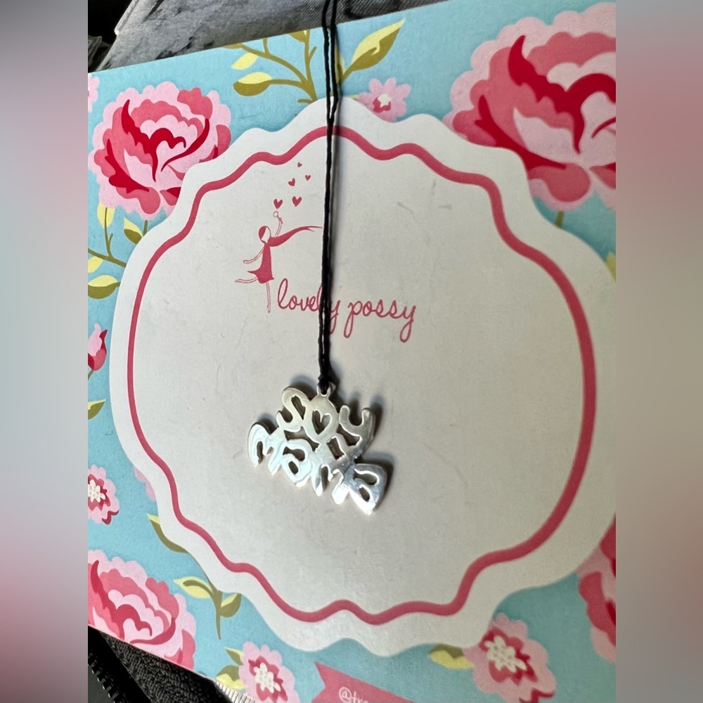 925 sterling silver Soy mamá charm on a thread cord.